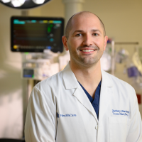 Dr. Zachary Warriner standing in an operating room.