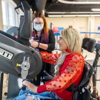 Kayla Lacy works on machine to improve her upper-body mobility.