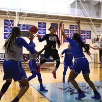 Amber and five of her teammates on the court playing a practice scrimmage.