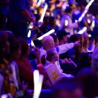 Dr. Adkins points excitedly at a UK game with his daughter.