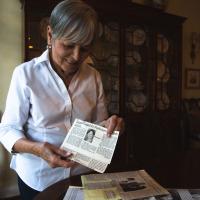 Gayle holds a news clipping about her activism.