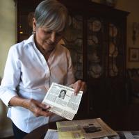 Gayle holds a news clipping about her activism.