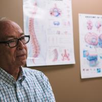 Gayle's husband Chet listens and waits in the examination room.