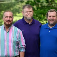 A photo of Helen’s three sons standing together and smiling for the camera.