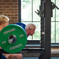 Joe and Cathy Marksteiner lifting weights together