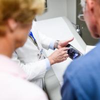 Dr. Lowell Anthony, a specialist at Markey, explains a recent scan to Joe and Cathy.