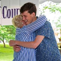 Sarah and Thad hug and smile at the Expressions of Courage event.