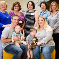 Arlo, Ezra, Stinky Monkey, and their family smile for a photo with the employees at UK HealthCare that made reuniting Ezra with Stinky Monkey possible.