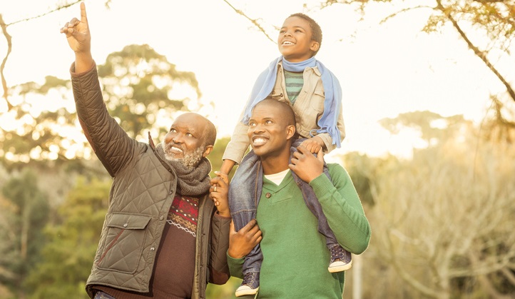 Three generations of a family enjoy a hike.