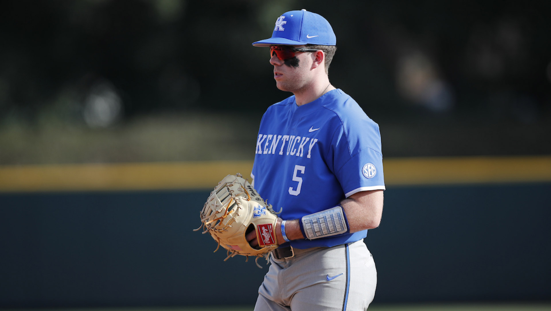 A candid shot of T.J. holding a bat over his shoulder and waiting for a pitch. His back is to the camera.